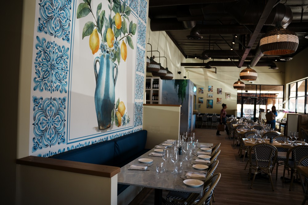 Sicilian ceramic tile wall and dining table at Amuri